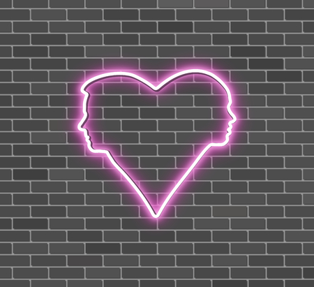 Neon heart silhouettes of boy and girl, brick wallの写真素材