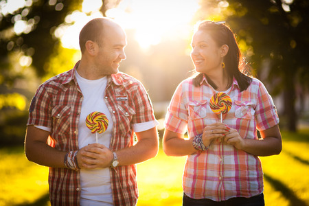 cheerful young couple relaxing in the park on the grass and in the cityの写真素材