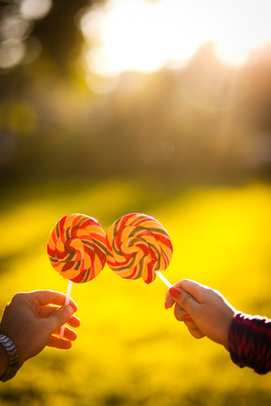 cheerful young couple relaxing in the park on the grass and in the cityの写真素材
