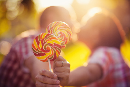 cheerful young couple relaxing in the park on the grass and in the cityの写真素材