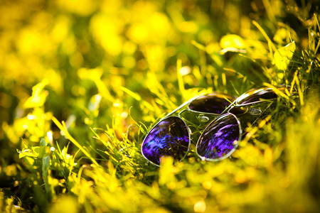 cheerful young couple relaxing in the park on the grass and in the cityの写真素材