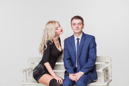 Young couple on a bench first date adultの写真素材