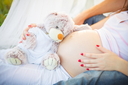 Young beautiful couple in anticipation of the baby pregnancy poppy fieldの写真素材