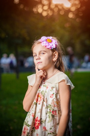 little girl lost in thought in parkの写真素材