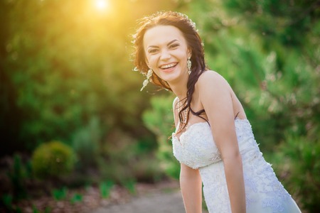 Cheerful bride showing happiness in natureの写真素材