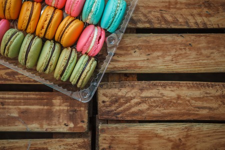Colorful French Macarons on wooden backgroundの写真素材