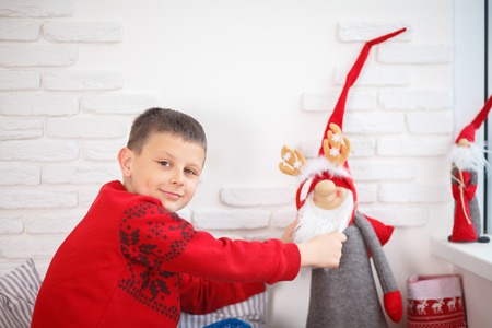 boy in a red sweater christmas tree new year alone