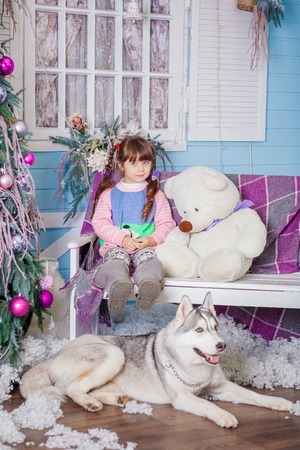Cute little girl with Husky puppyの写真素材