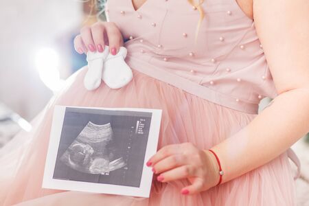 pregnant woman with ultrasound photoの写真素材