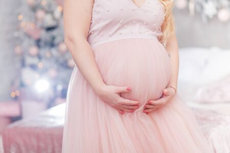 pregnant woman in rose dressの写真素材