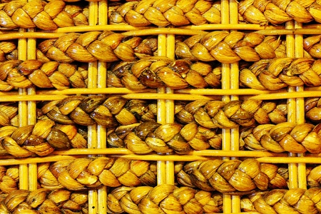 Handmade wooden entwined seats piled up on top of each other. の写真素材