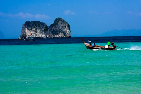 wooden boat in stunning turquoise water のeditorial素材