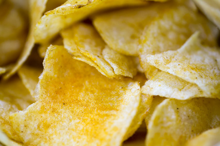Close up potato chips on wood top view background.