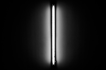 Detail of a fluorescent light tube mounted on a wallの写真素材