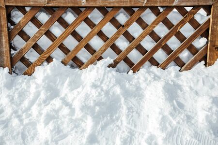 The brown wood texture with snow flakes over it