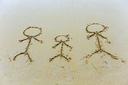 People family drawn in the sandの写真素材