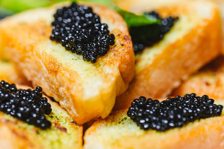 Black caviar on toast. Close up of black caviar on bread.の写真素材