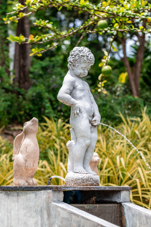 Ceramic statue of a child in the garden. Selective focus.の写真素材