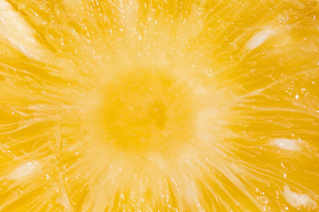 Macro shot of a orange slice with water droplets. Abstract backgroundの写真素材