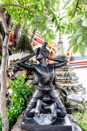 Statue of a woman in front of Wat Pho in Bangkok, Thailandの写真素材