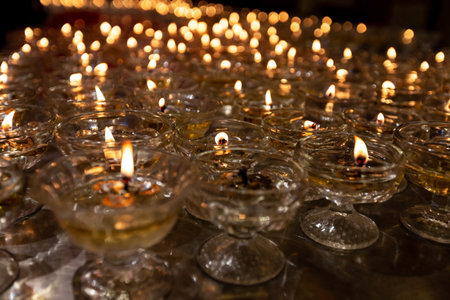 Candles in a glass bowl on a table in the church.