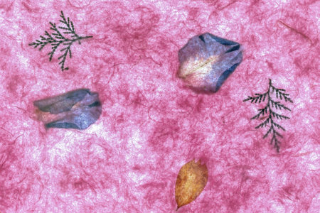 Crumpled paper with a pattern of blue and pink leaves.