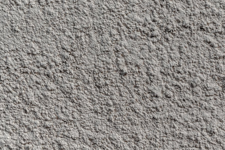 Texture of old rustic wall covered with gray stucco as backgroundの写真素材