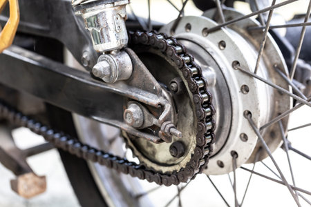 Detail of the rear wheel and chain of a vintage motorcycle.の写真素材