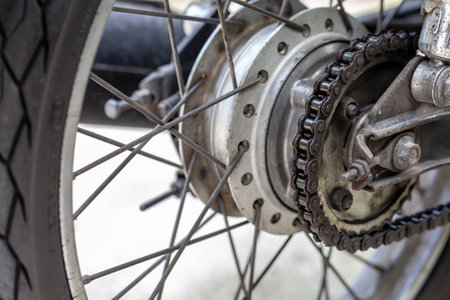 Close up of old motorcycle wheel with chain and disc brake, selective focusの写真素材