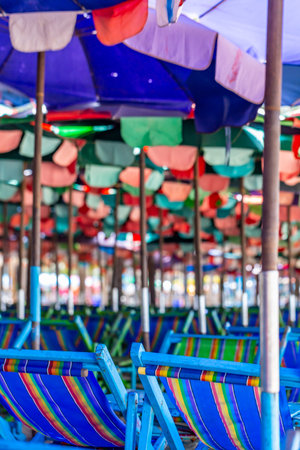 Colorful beach chairs with umbrella in public park,Thailand.の写真素材
