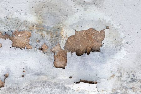 Old concrete wall with peeling paint. Abstract background for design.