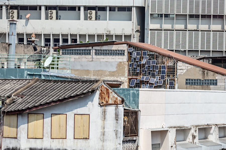 Roofs of old buildings with solar panels in Bangkok, Thailand