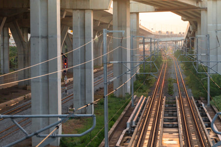 Railway through the city at sunset, view from below, vertical
