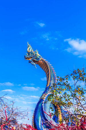 Serpent or Naga statue on blue sky background, Thailand.