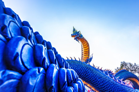 Beautiful Naga statue on blue sky background at public park, Thailand.の写真素材