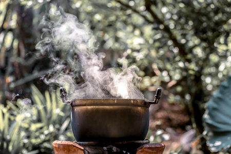 Cauldron with boiling water in the garden. Selective focus.