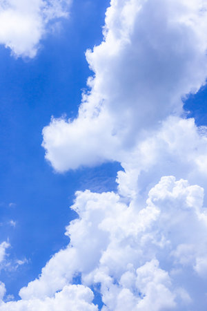 Blue sky background with tiny clouds. The vast blue sky and clouds sky on sunny day. White fluffy...