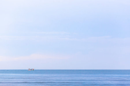 Fishing boat in the sea on blue sky background, Thailand.
