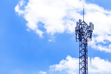 Telecommunication tower with blue sky and white cloud background. Technology background.