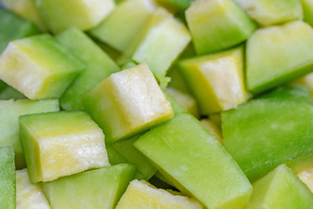 Slices of green melon close-up for background.