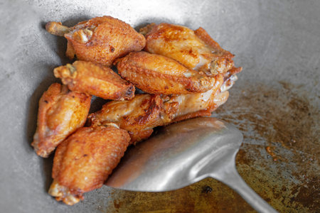 Fried chicken wings on a metal plate, close-up.の写真素材