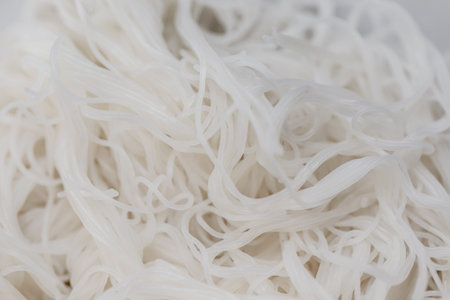 close up of white rice vermicelli noodles on white background