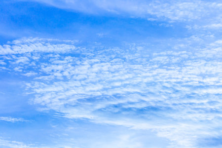 Blue sky background with tiny clouds. Abstract background of blue sky.