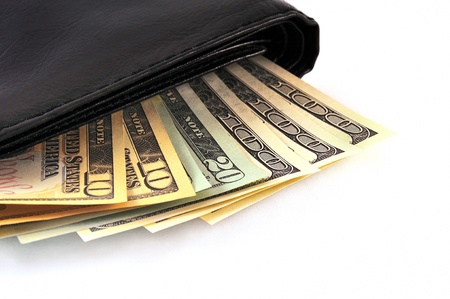 The black leather wallet with money isolated on the white backgroundの写真素材