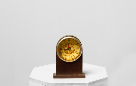 A vintage clock isolated on gray background.