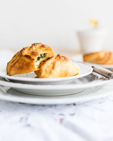 Homemade puff pastry filled with wild garlic spinach and sour cream. Selective focus.の写真素材