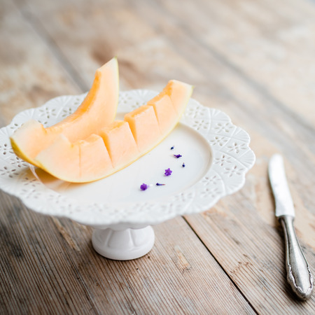 two melon slices on beautiful plate, selective focusの写真素材