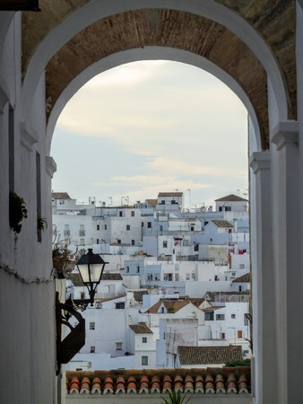 A typical white village of Andalusia in Spain seen by an arcの写真素材