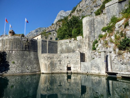 A fortress around the city of Kotor in Montenegro with reflections on the water