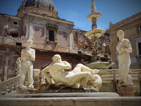 Some statues of Piazza Pretoria in Palermo with an elderly man lying down surrounded by a man and a women, Palermo, Italy, Sicilyのeditorial素材